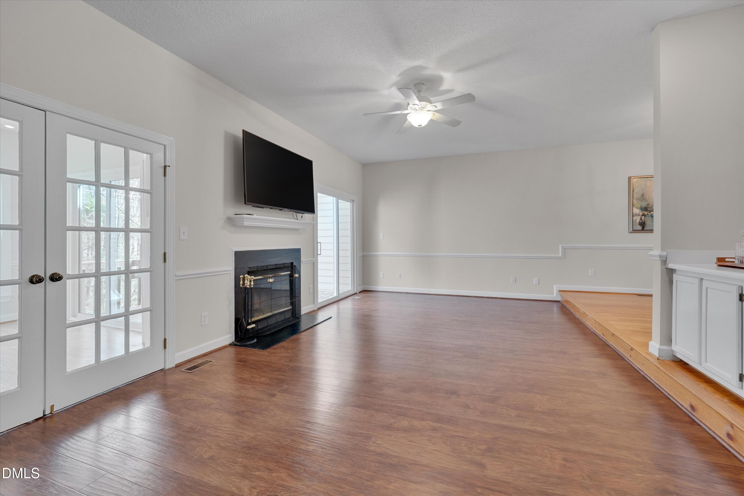 3 Preakness Drive Durham, NC 27713 - Photo 13 of 62 a view of a livingroom with a fireplace wooden floor and window