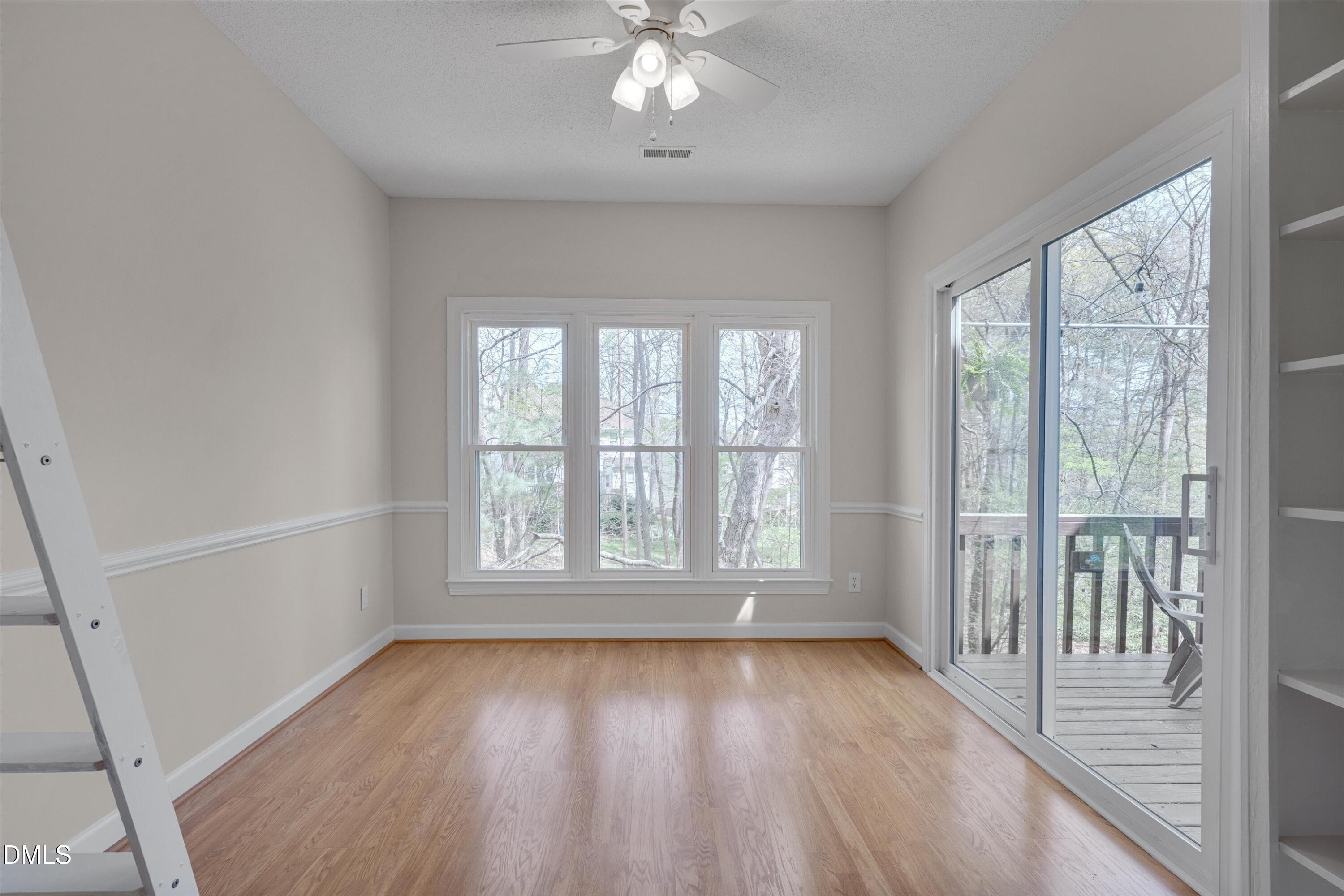 3 Preakness Drive Durham, NC 27713 - Photo 17 of 62 an empty room with wooden floor and windows