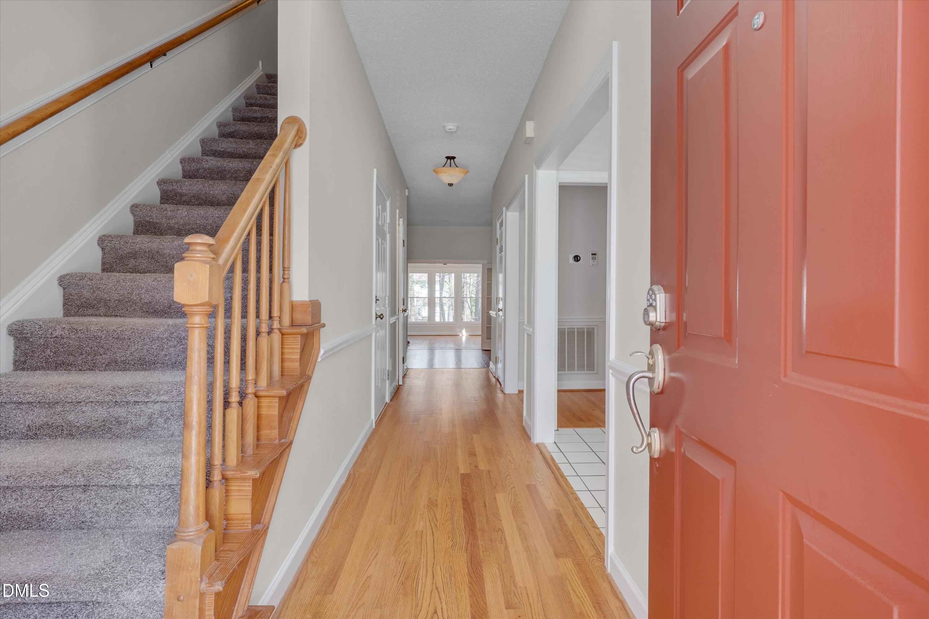 3 Preakness Drive Durham, NC 27713 - Photo 3 of 62 a view of a hallway with wooden floor and staircase