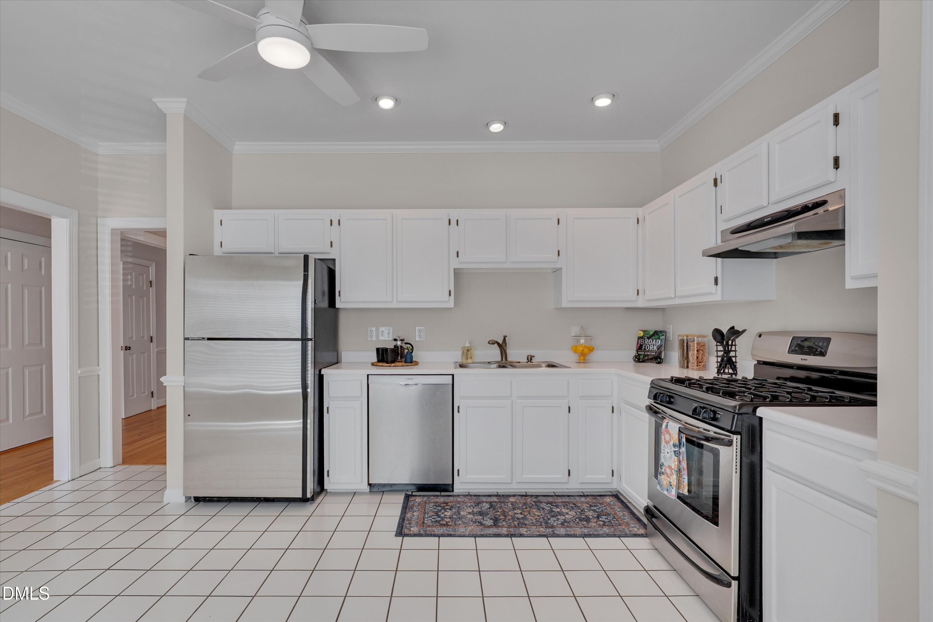3 Preakness Drive Durham, NC 27713 - Photo 8 of 62 a kitchen with a refrigerator a stove top oven and cabinets