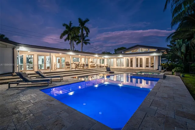 a view of swimming pool with a table and chairs