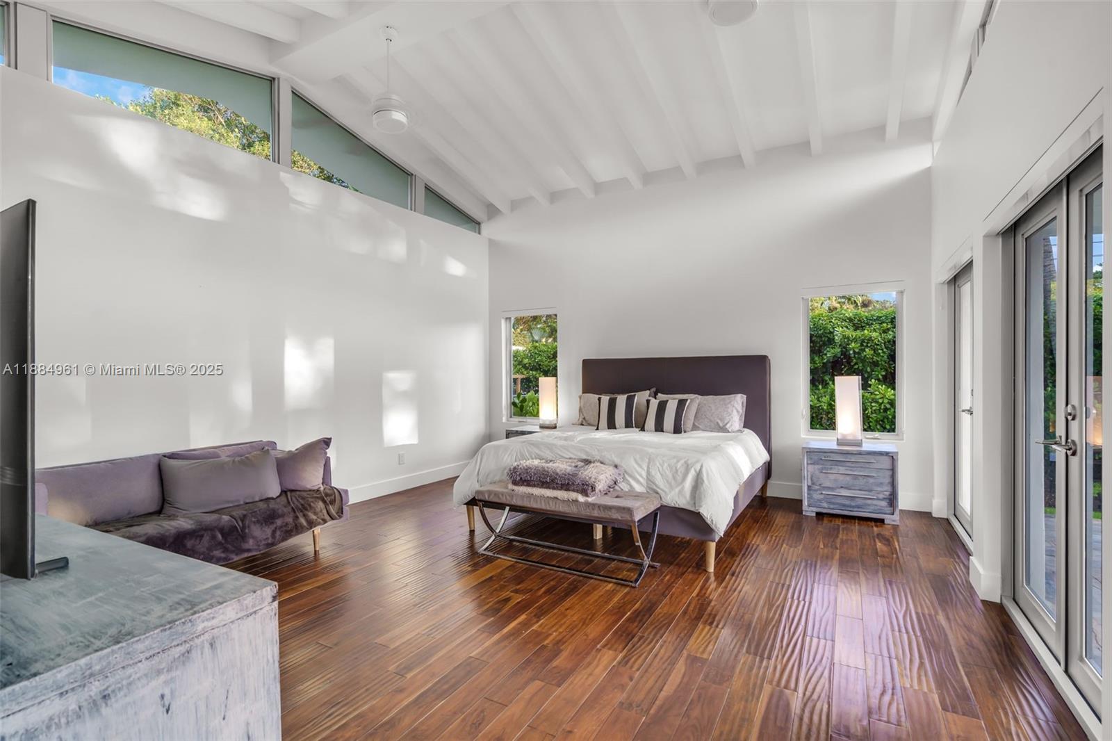 7550 Southwest 60th Street Miami, FL 33143 - Photo 21 of 64 a spacious bedroom with a bed and a wooden floor