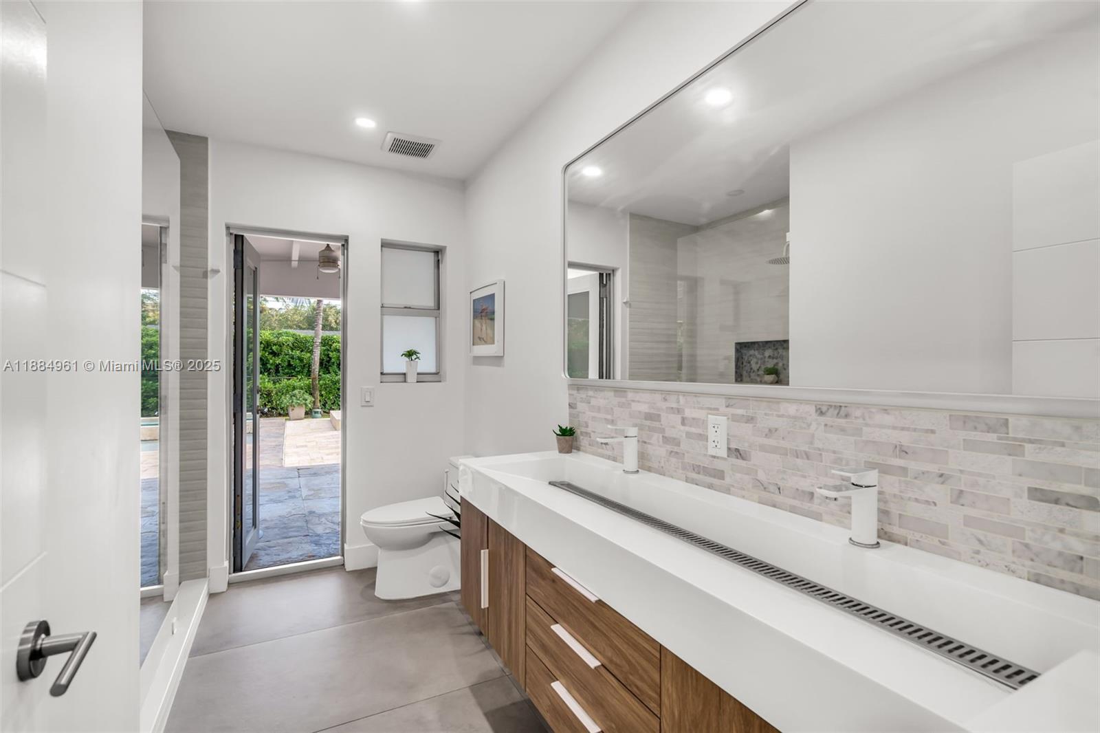 7550 Southwest 60th Street Miami, FL 33143 - Photo 30 of 64 a spacious bathroom with a double vanity sink toilet and a tub