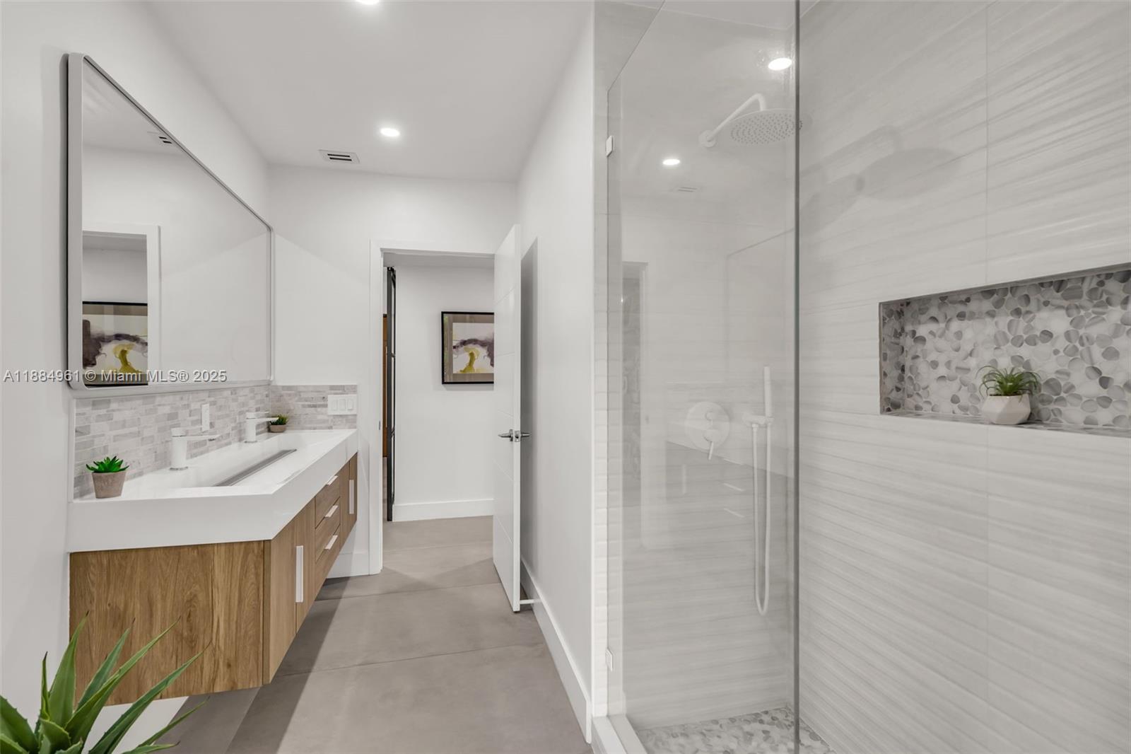 7550 Southwest 60th Street Miami, FL 33143 - Photo 31 of 64 a bathroom with a sink a mirror and a shower