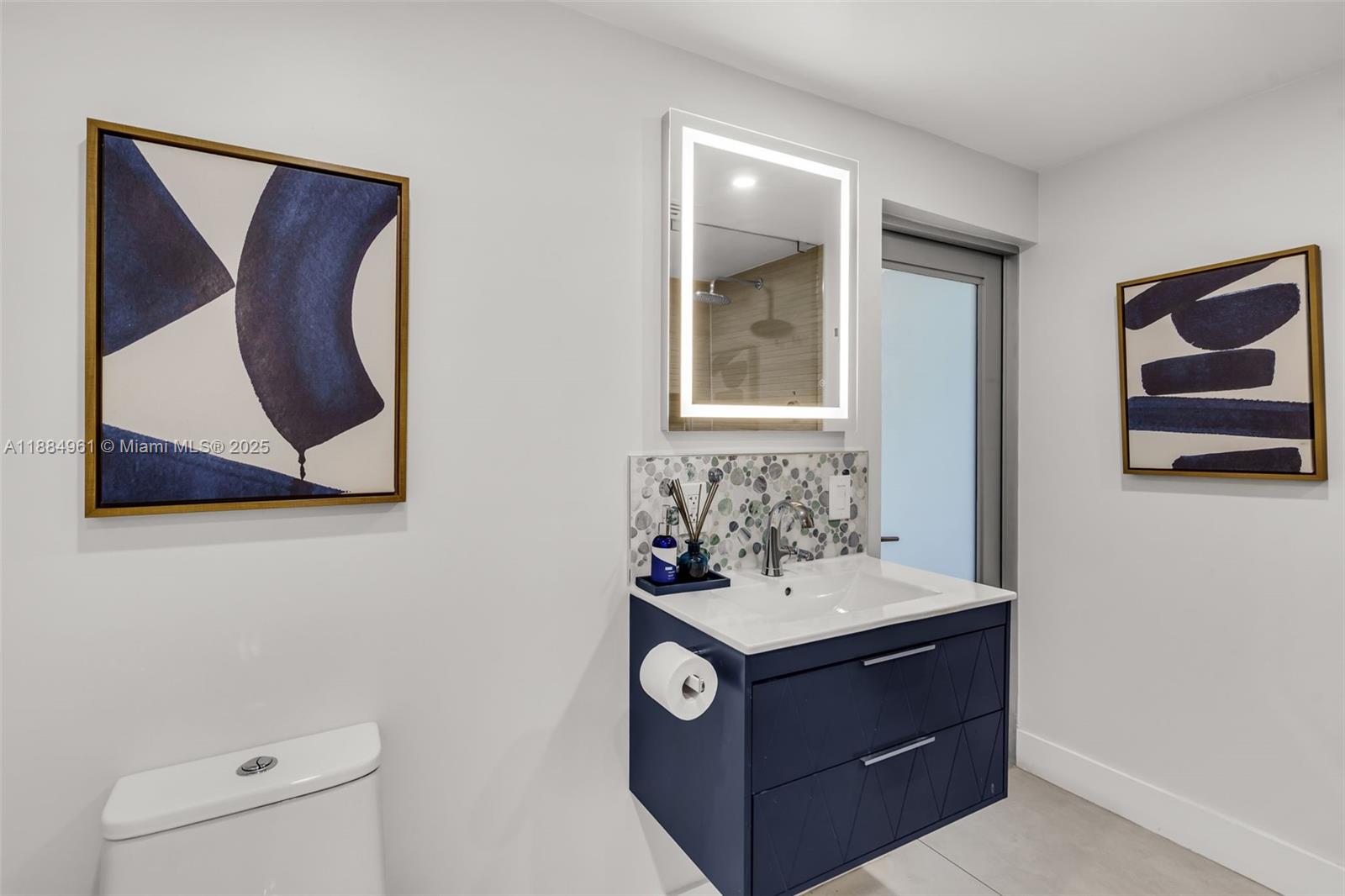 7550 Southwest 60th Street Miami, FL 33143 - Photo 38 of 64 a bathroom with a sink and a mirror