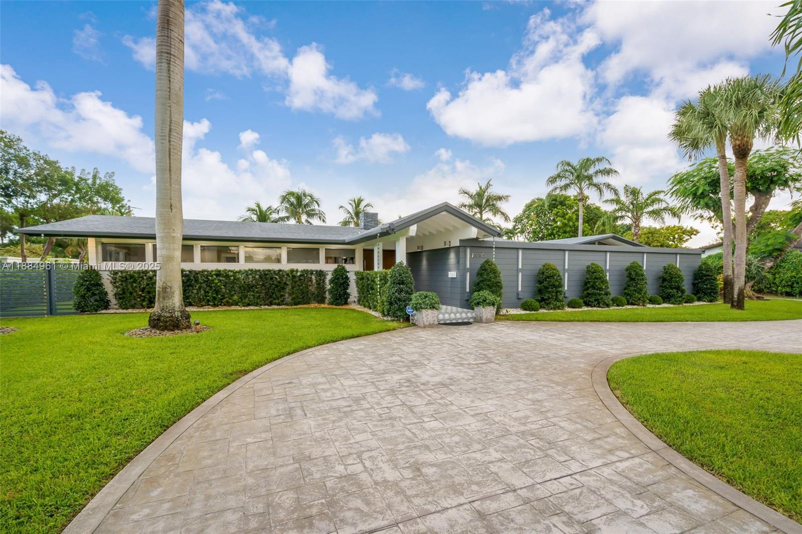 7550 Southwest 60th Street Miami, FL 33143 - Photo 63 of 64 a view of a white house with a big yard and potted plants