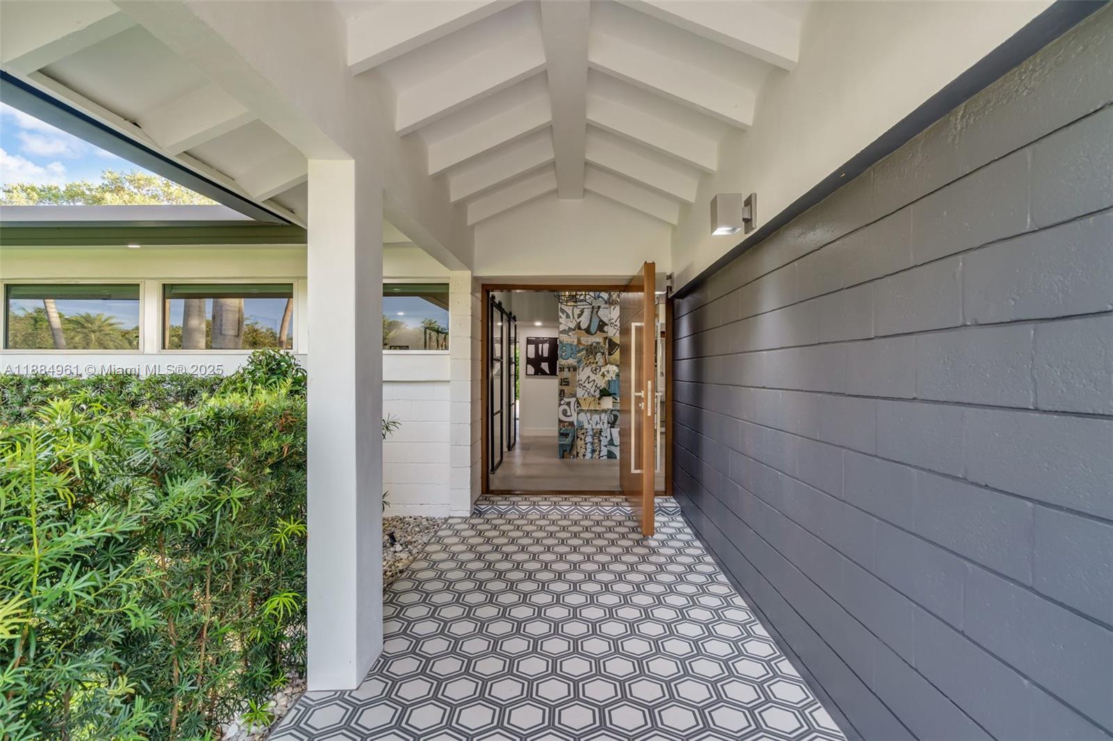 7550 Southwest 60th Street Miami, FL 33143 - Photo 7 of 64 a view of a porch with a table and chairs
