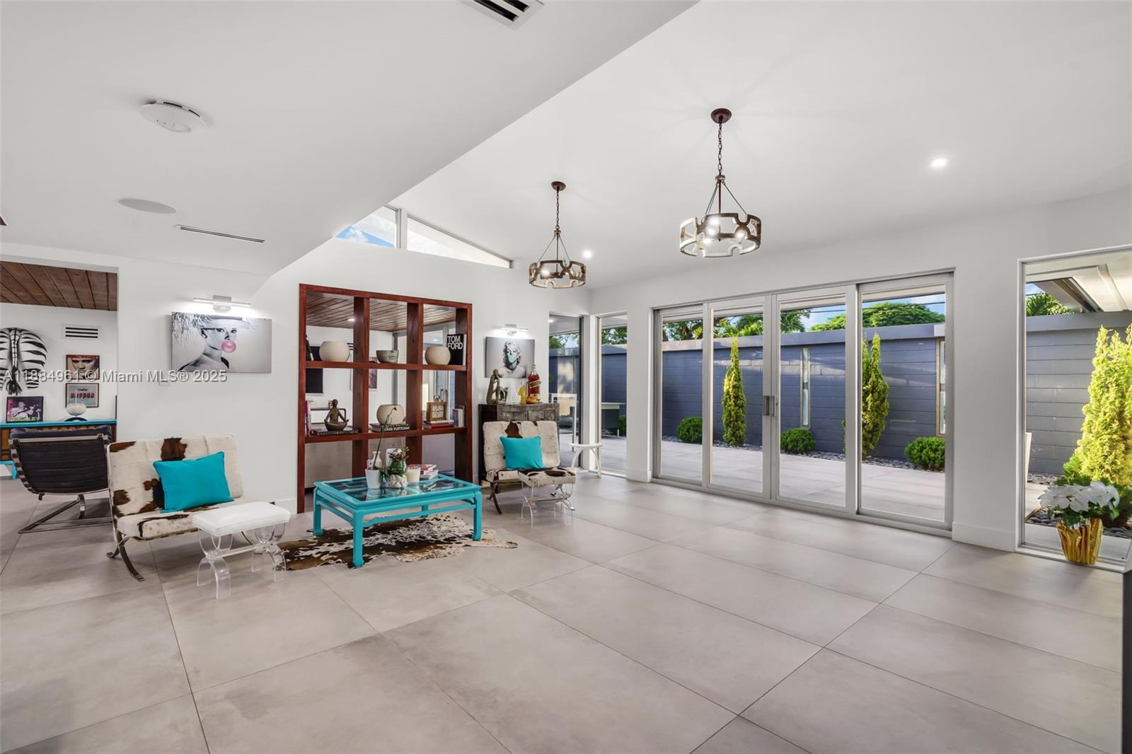 7550 Southwest 60th Street Miami, FL 33143 - Photo 9 of 64 Wall of glass with access to the front courtyard for seamless indoor-outdoor entertaining