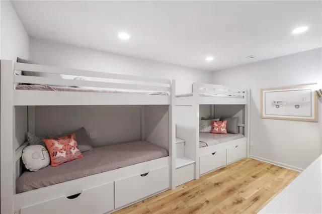 a living room with furniture a flat screen tv and floor to ceiling window