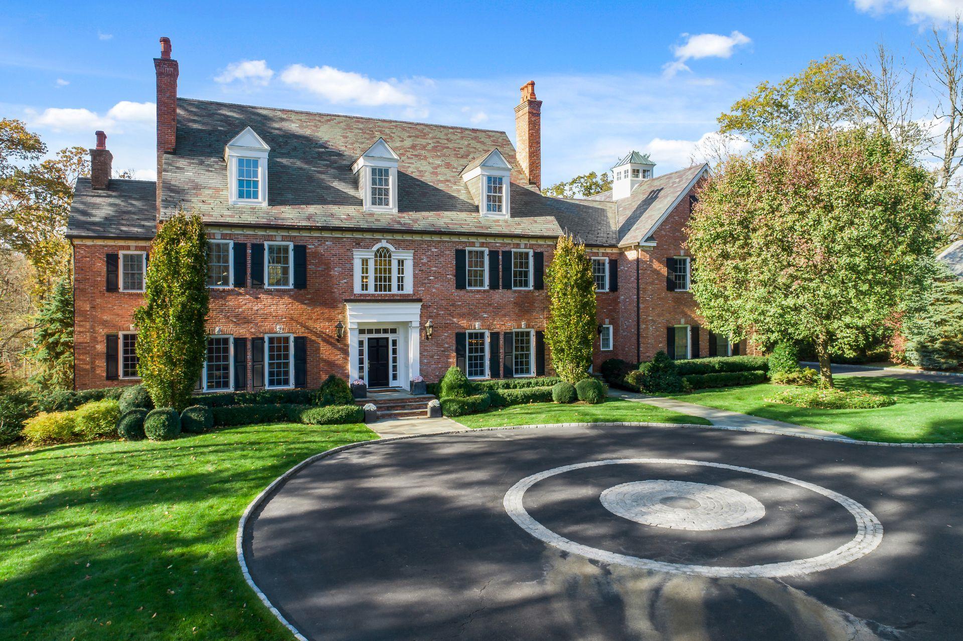494 Ponus Ridge Road New Canaan, CT 06840 - Photo 1 of 30 a front view of a house with a yard and trees