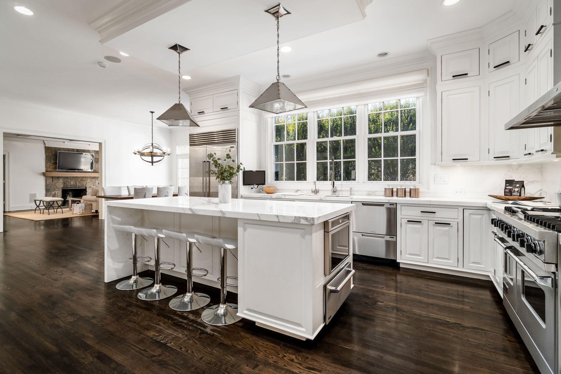 494 Ponus Ridge Road New Canaan, CT 06840 - Photo 11 of 30 a kitchen with a sink stove and cabinets
