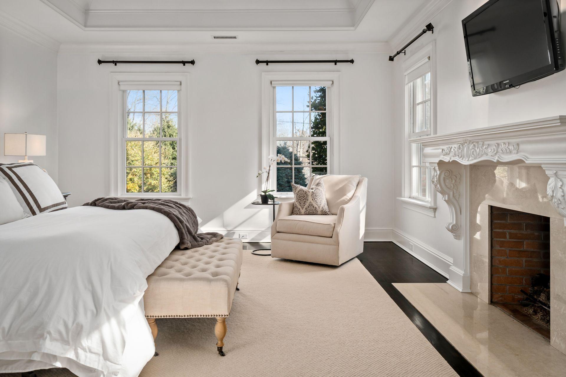 494 Ponus Ridge Road New Canaan, CT 06840 - Photo 15 of 30 a bedroom with a bed and a fireplace