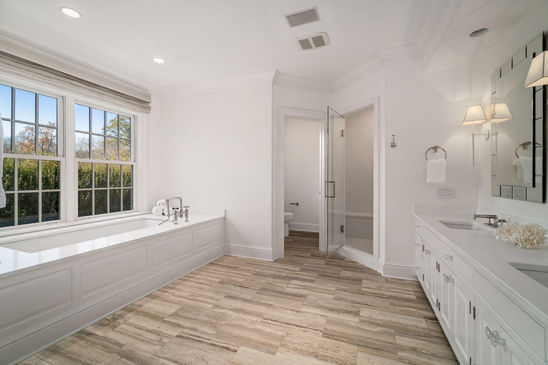 494 Ponus Ridge Road New Canaan, CT 06840 - Photo 16 of 30 a bathroom with a tub sink shower and a mirror