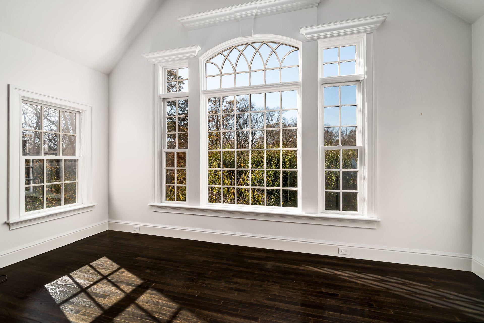 494 Ponus Ridge Road New Canaan, CT 06840 - Photo 18 of 30 an empty room with wooden floor and windows
