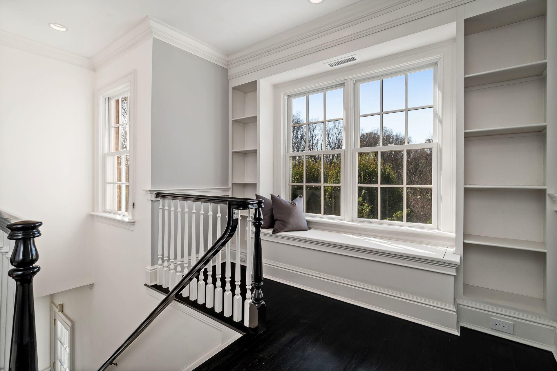 494 Ponus Ridge Road New Canaan, CT 06840 - Photo 20 of 30 a view of staircase with white walls and a window