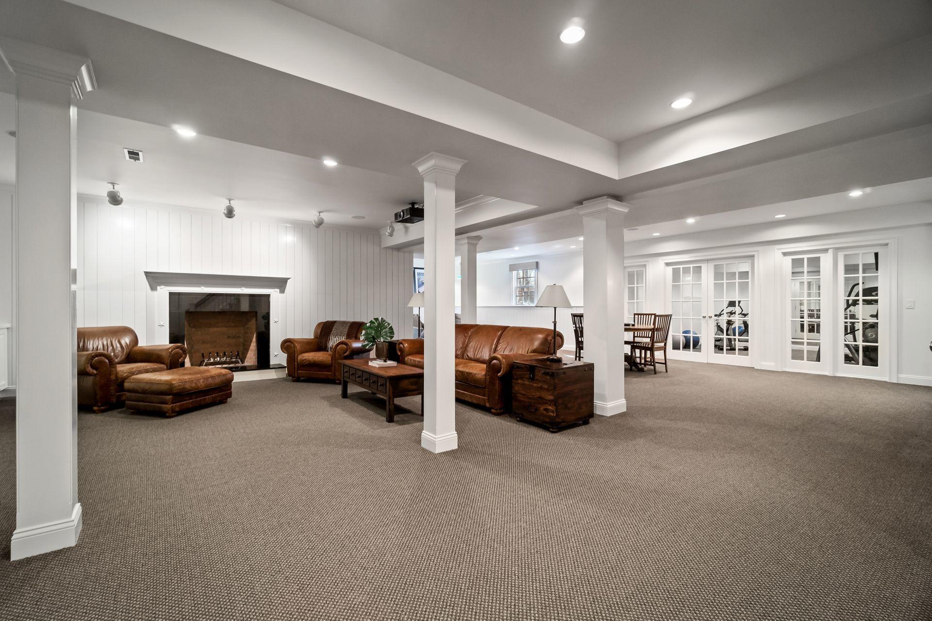 494 Ponus Ridge Road New Canaan, CT 06840 - Photo 22 of 30 a living room with furniture and a fireplace