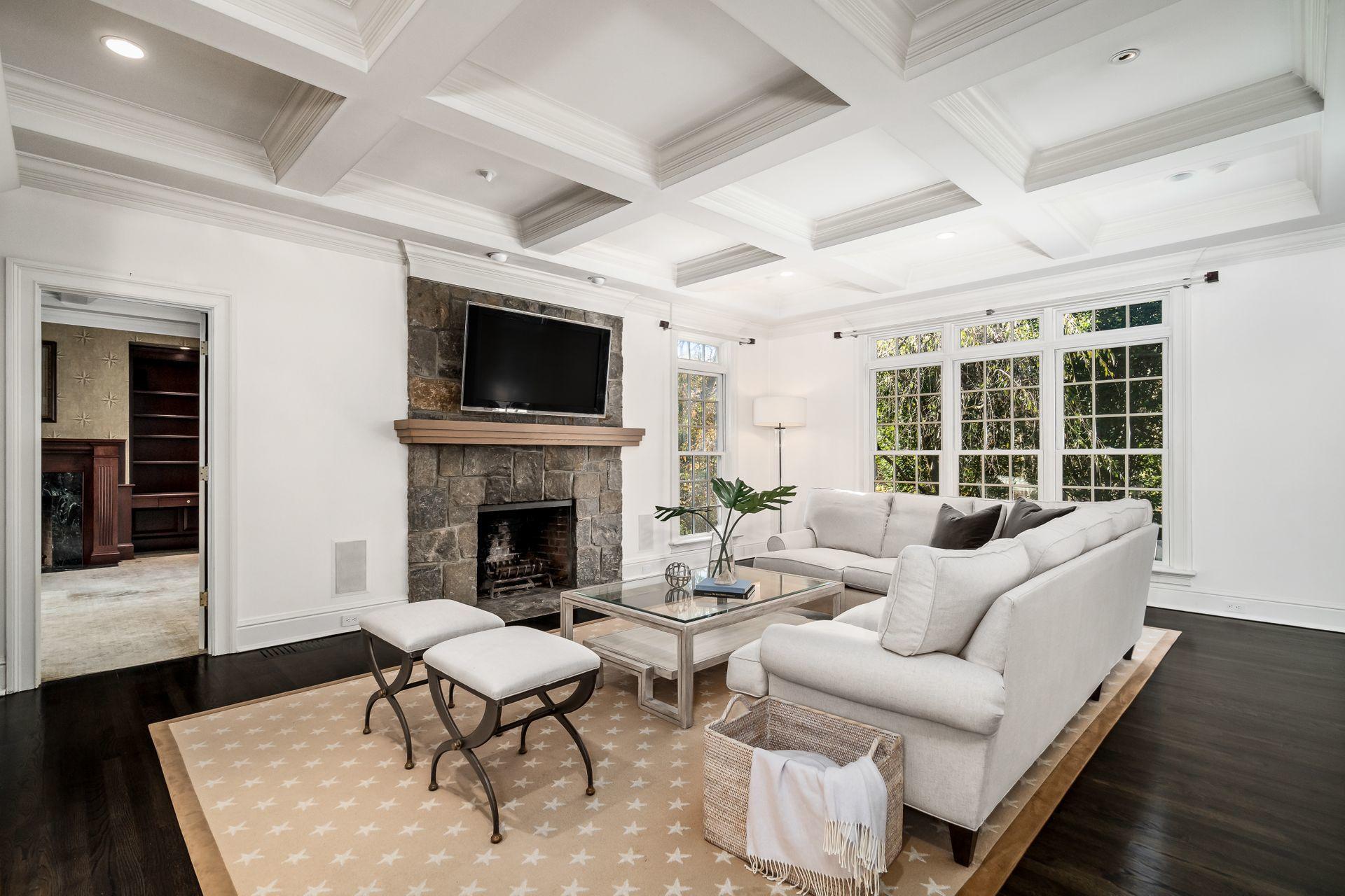 494 Ponus Ridge Road New Canaan, CT 06840 - Photo 8 of 30 a living room with furniture a fireplace and a flat screen tv