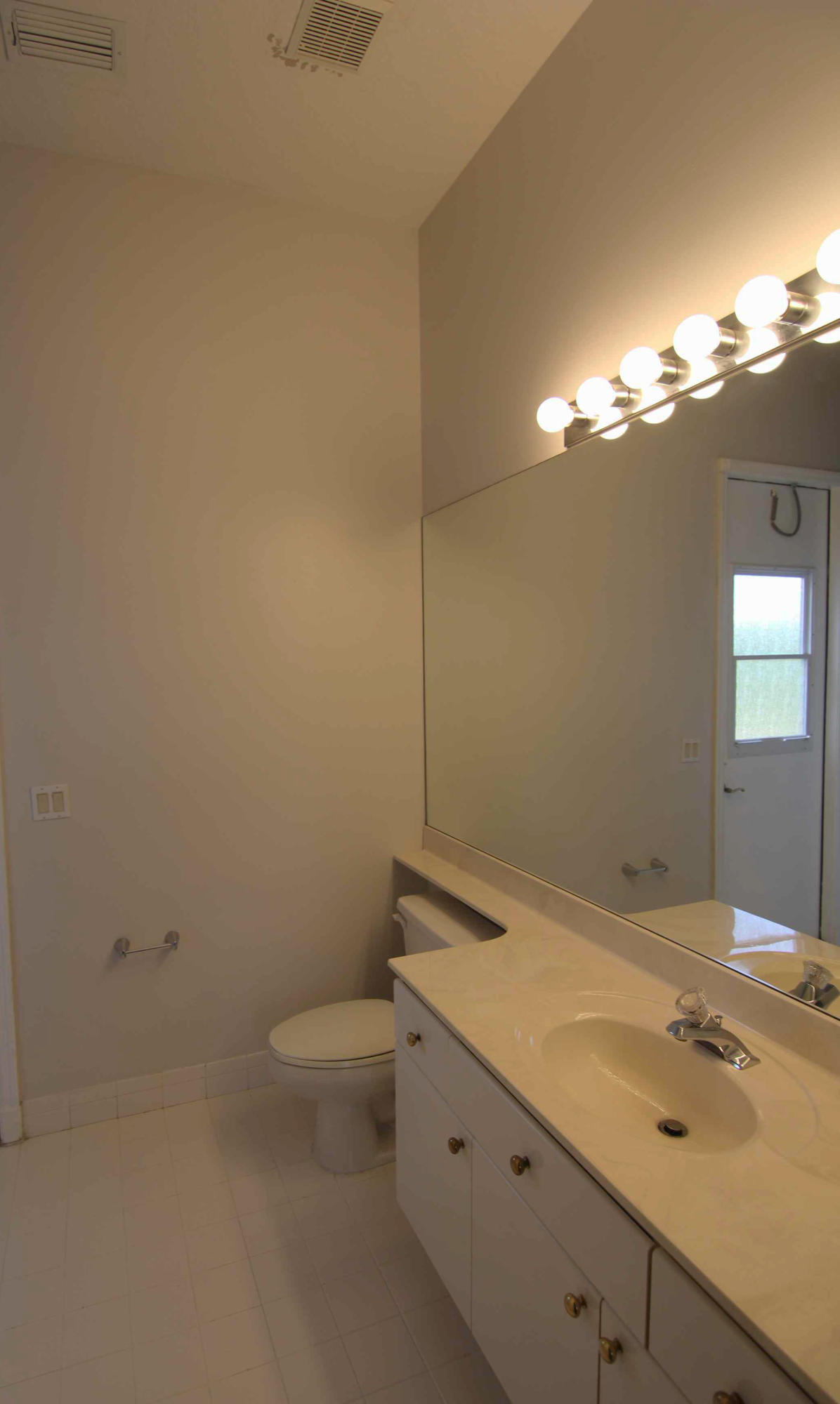18540 Ocean Mist Drive Boca Raton, FL 33498 - Photo 11 of 37 a bathroom with a granite countertop sink and a toilet
