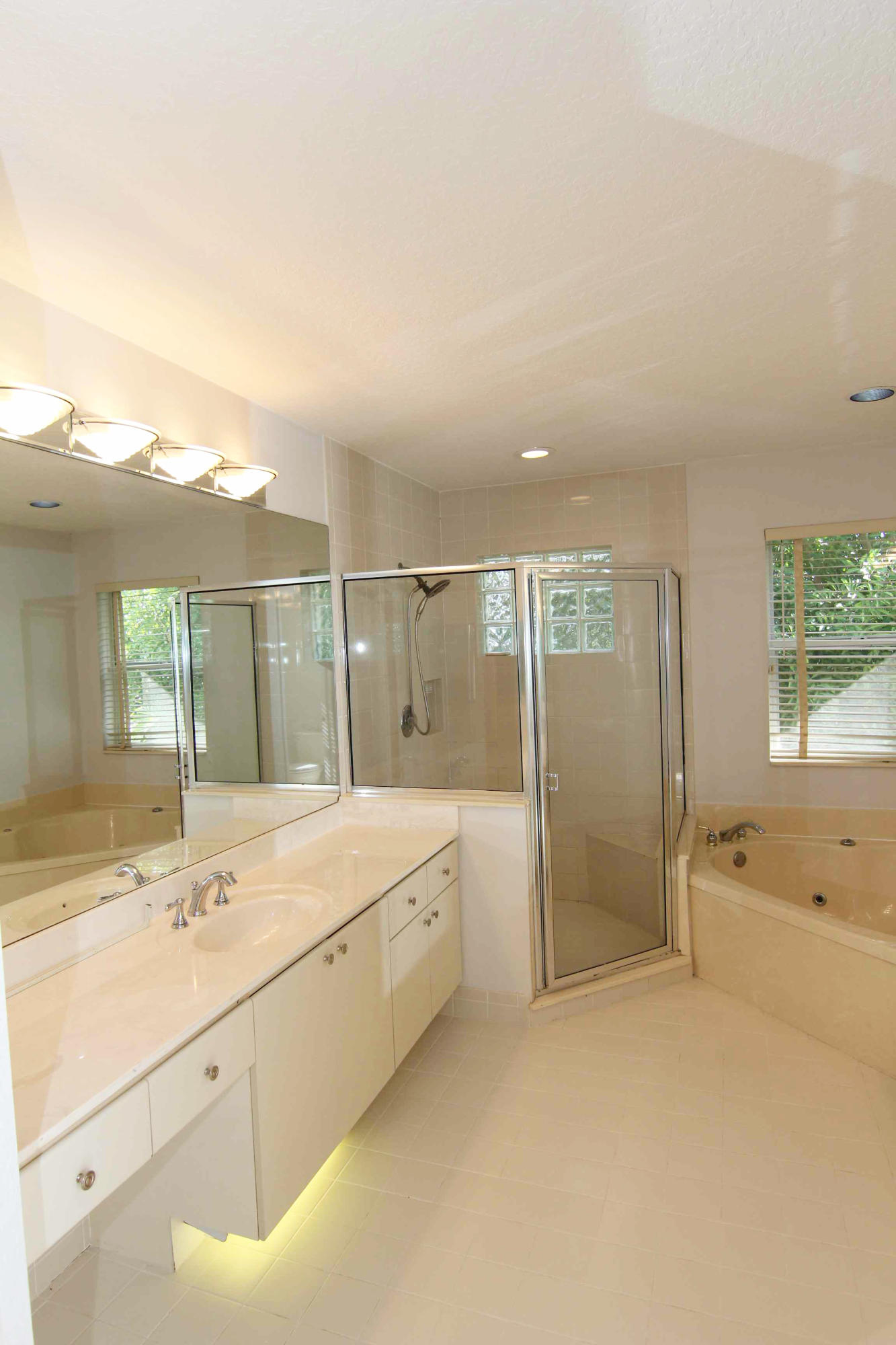 18540 Ocean Mist Drive Boca Raton, FL 33498 - Photo 17 of 37 a bathroom with a shower sink and mirror