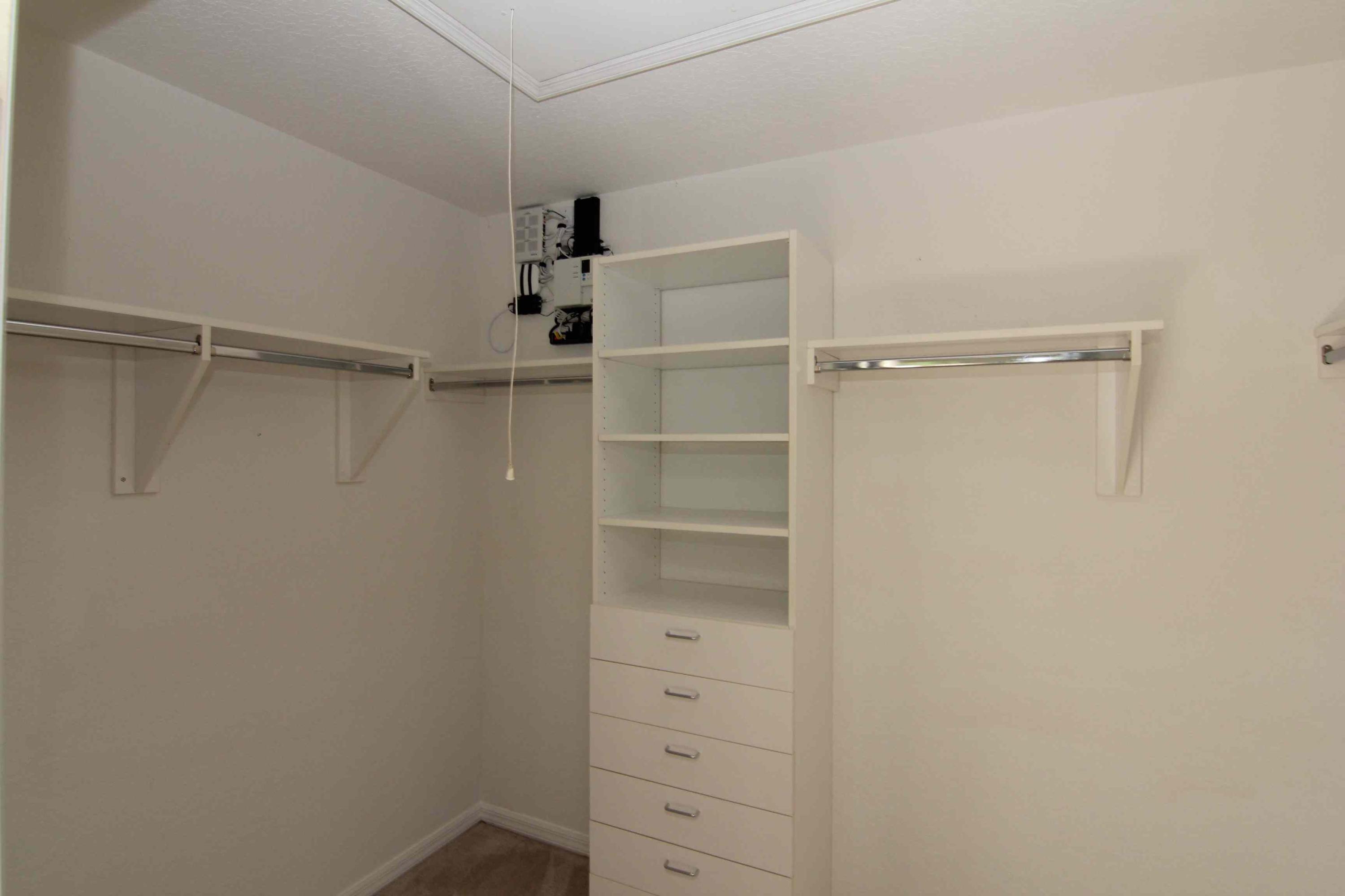 18540 Ocean Mist Drive Boca Raton, FL 33498 - Photo 18 of 37 a view of walk in closet with empty racks