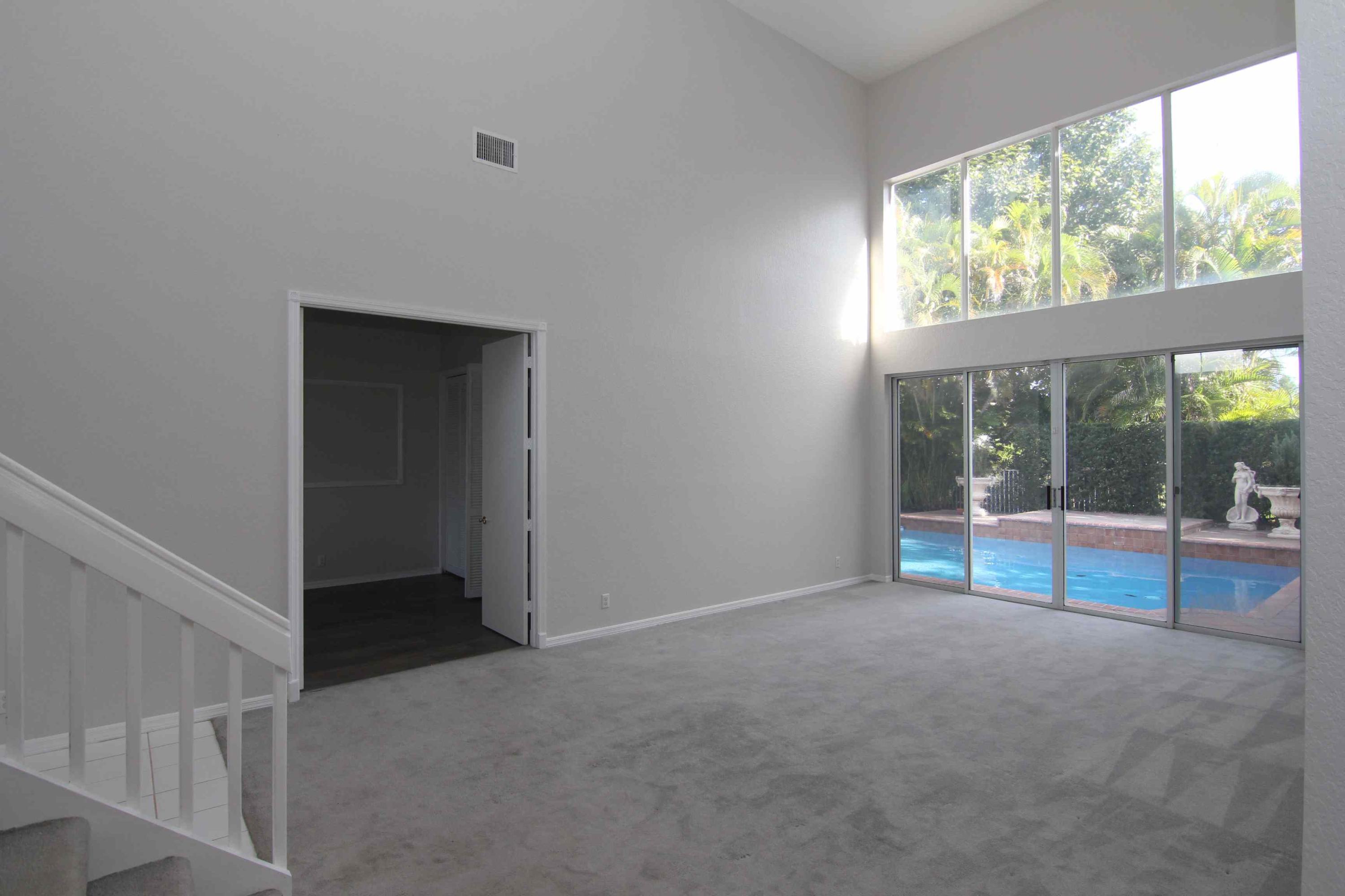 18540 Ocean Mist Drive Boca Raton, FL 33498 - Photo 2 of 37 an empty room with sliding door and wooden floor