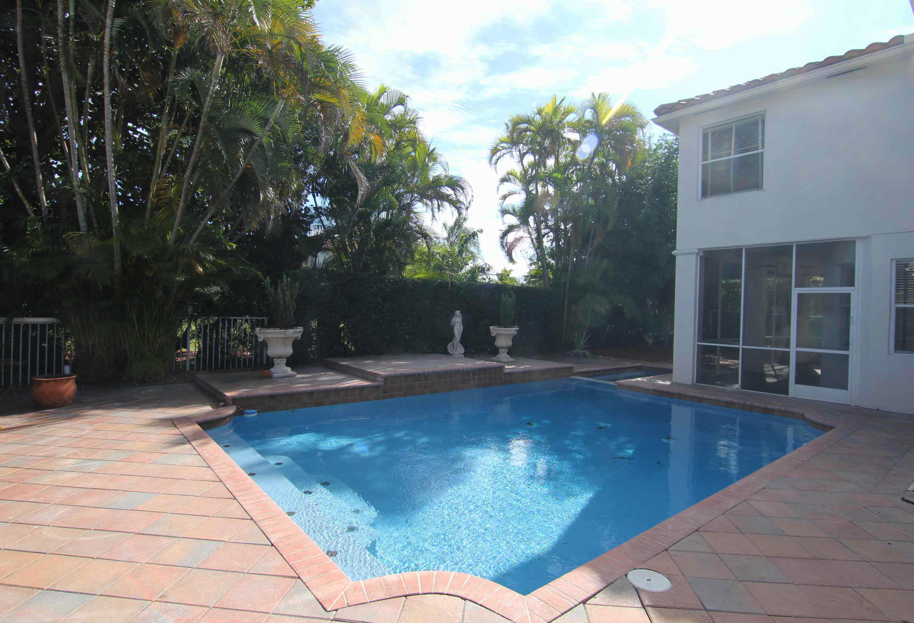 18540 Ocean Mist Drive Boca Raton, FL 33498 - Photo 26 of 37 a swimming pool with outdoor seating and yard