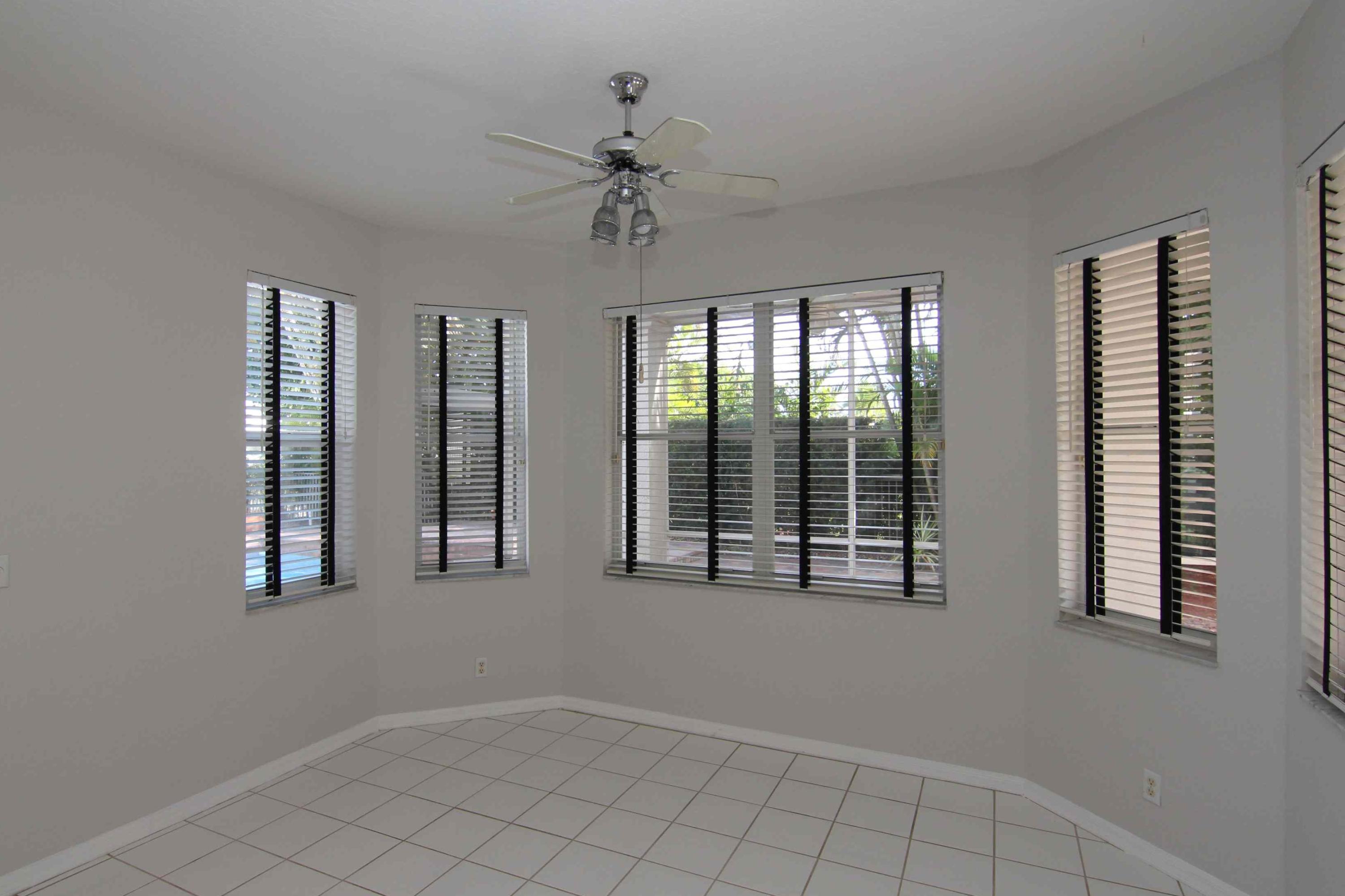 18540 Ocean Mist Drive Boca Raton, FL 33498 - Photo 7 of 37 a view of an empty room with window and chandelier fan