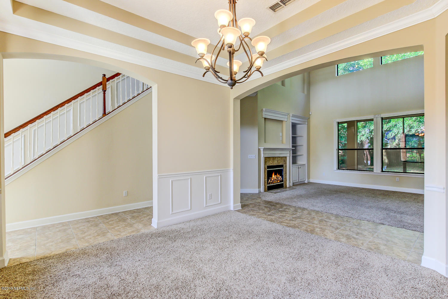 3993 Reds Gait Lane Jacksonville, FL 32223 - Photo 16 of 72 a view of a big room with fireplace chandelier and windows