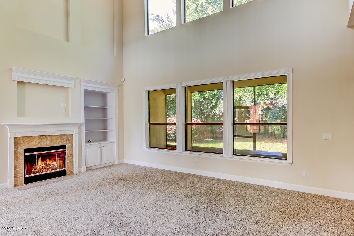 3993 Reds Gait Lane Jacksonville, FL 32223 - Photo 17 of 72 an empty room with furniture and a fireplace