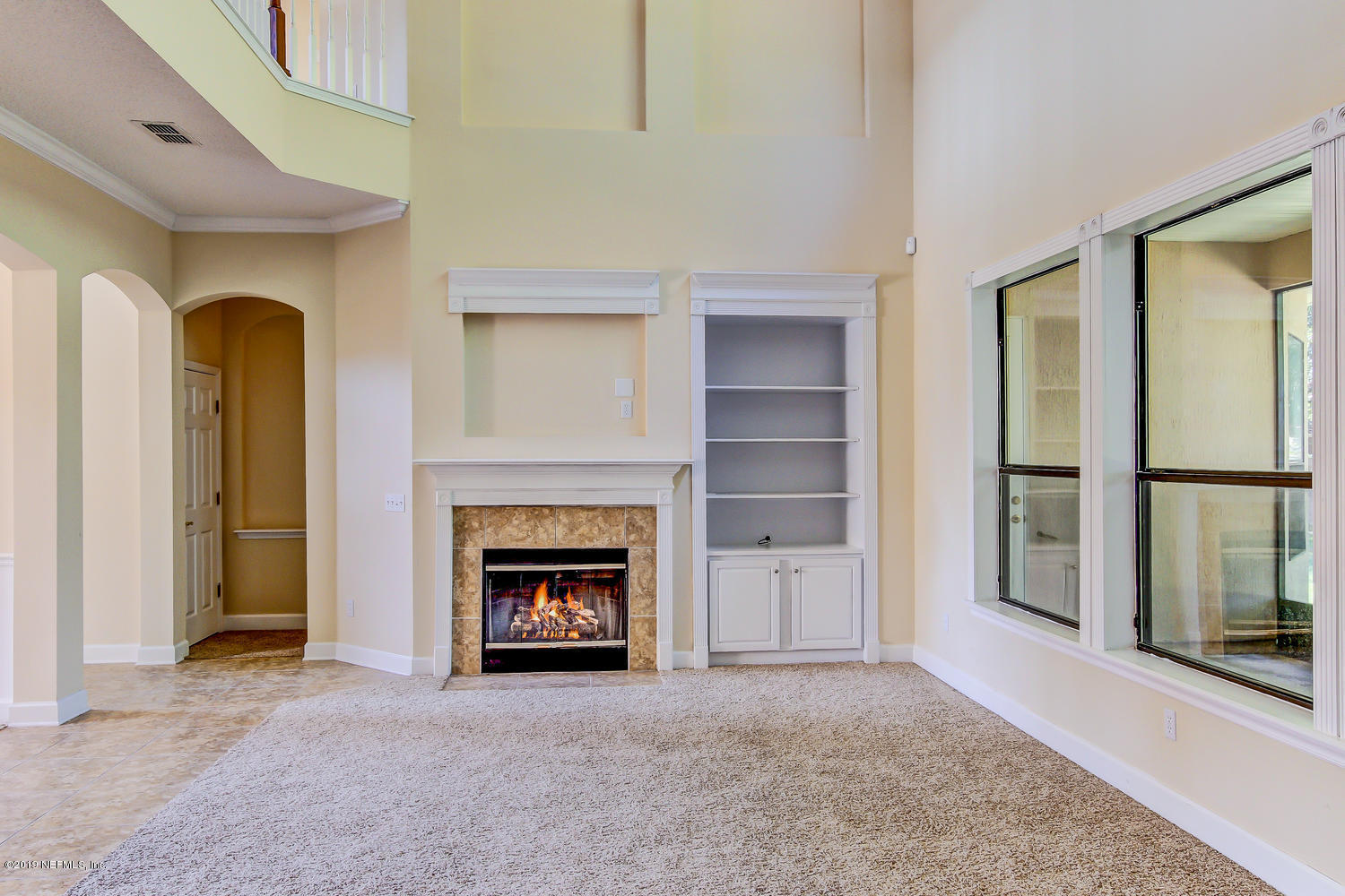 3993 Reds Gait Lane Jacksonville, FL 32223 - Photo 18 of 72 a view of an empty room with a fireplace and a window