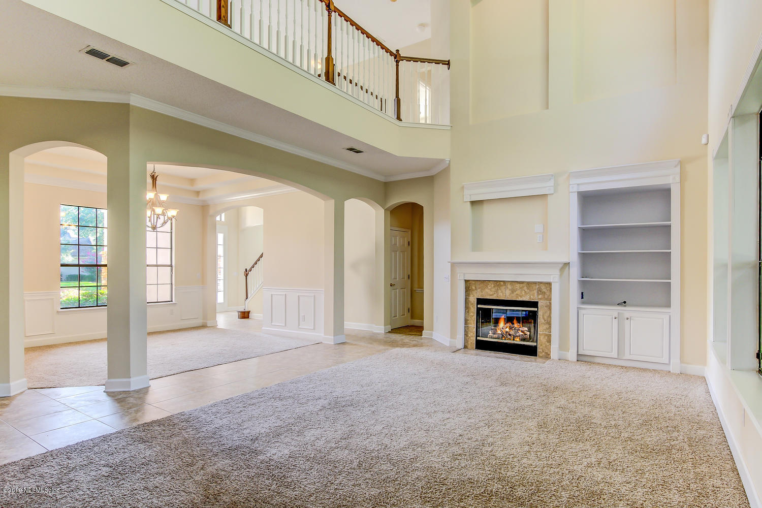 3993 Reds Gait Lane Jacksonville, FL 32223 - Photo 19 of 72 a view of an empty room with a fireplace and a window