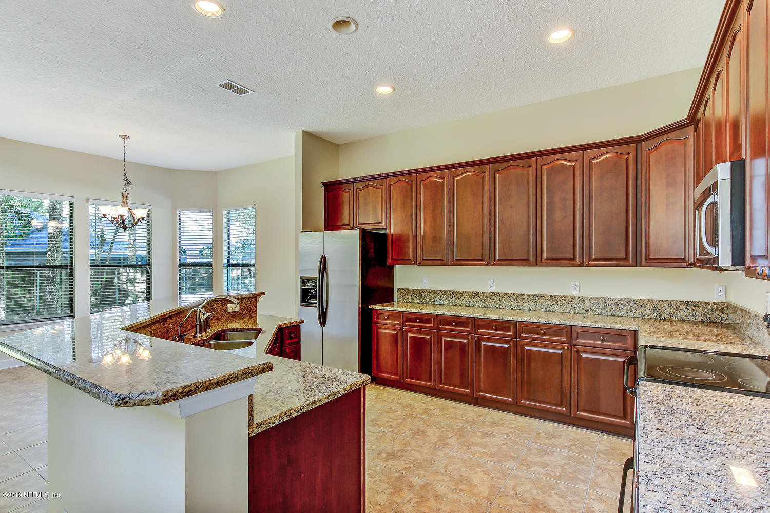 3993 Reds Gait Lane Jacksonville, FL 32223 - Photo 23 of 72 a kitchen with stainless steel appliances granite countertop a sink and a refrigerator