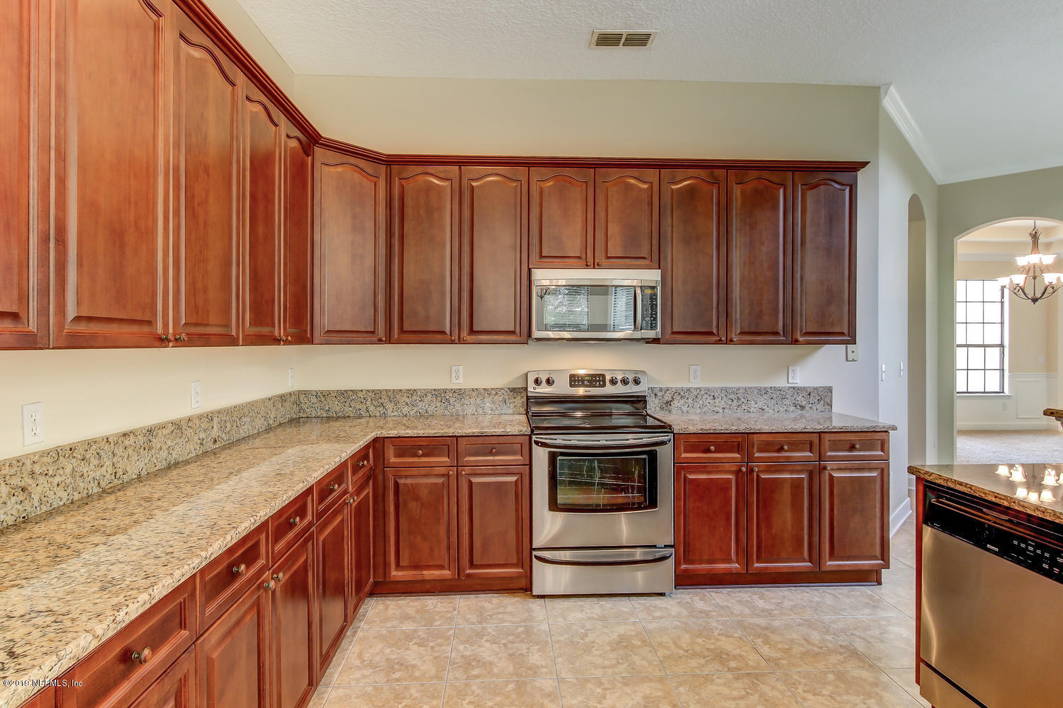 3993 Reds Gait Lane Jacksonville, FL 32223 - Photo 24 of 72 a kitchen with stainless steel appliances granite countertop a stove a sink and a microwave