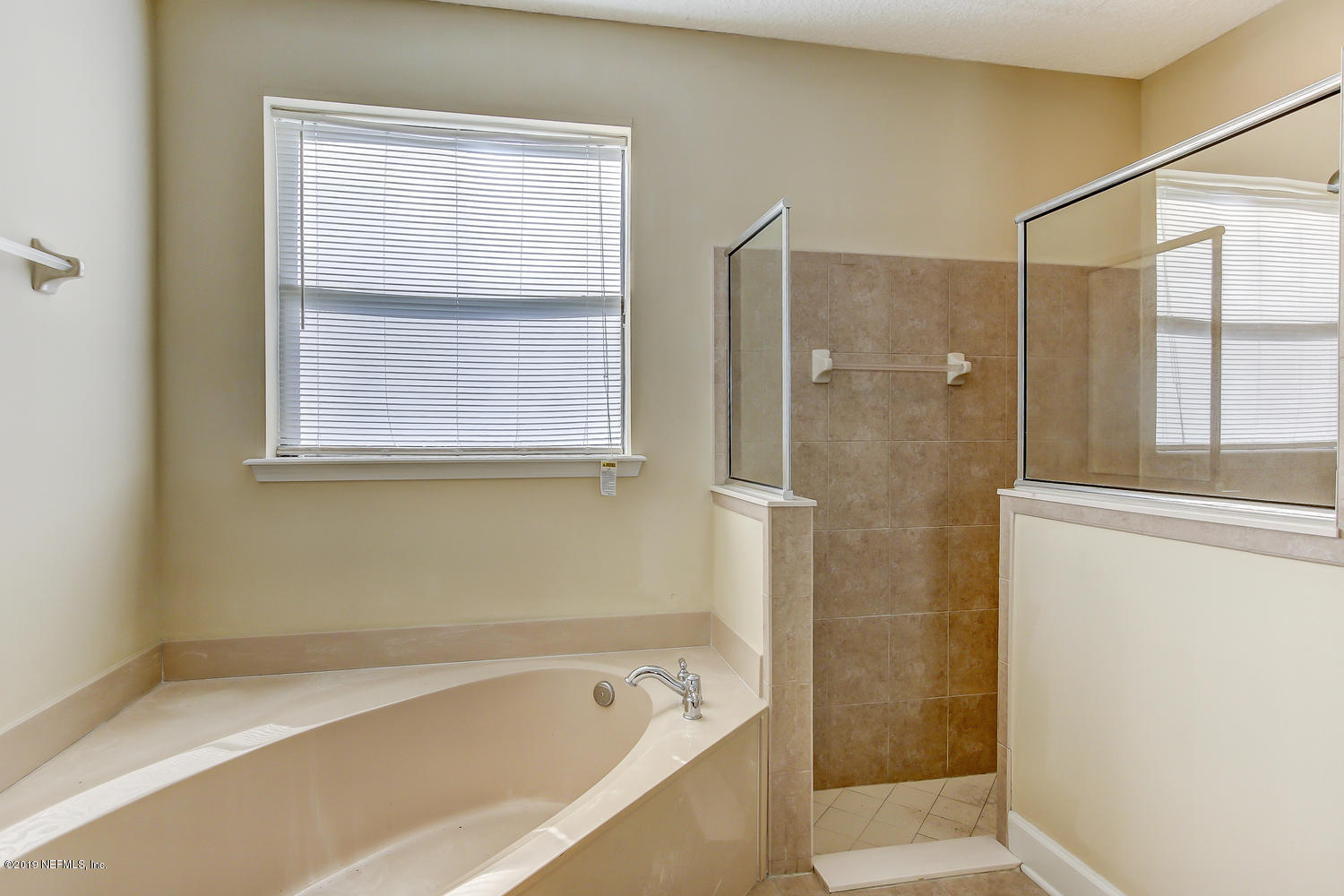 3993 Reds Gait Lane Jacksonville, FL 32223 - Photo 38 of 72 a bathroom with a bathtub and shower