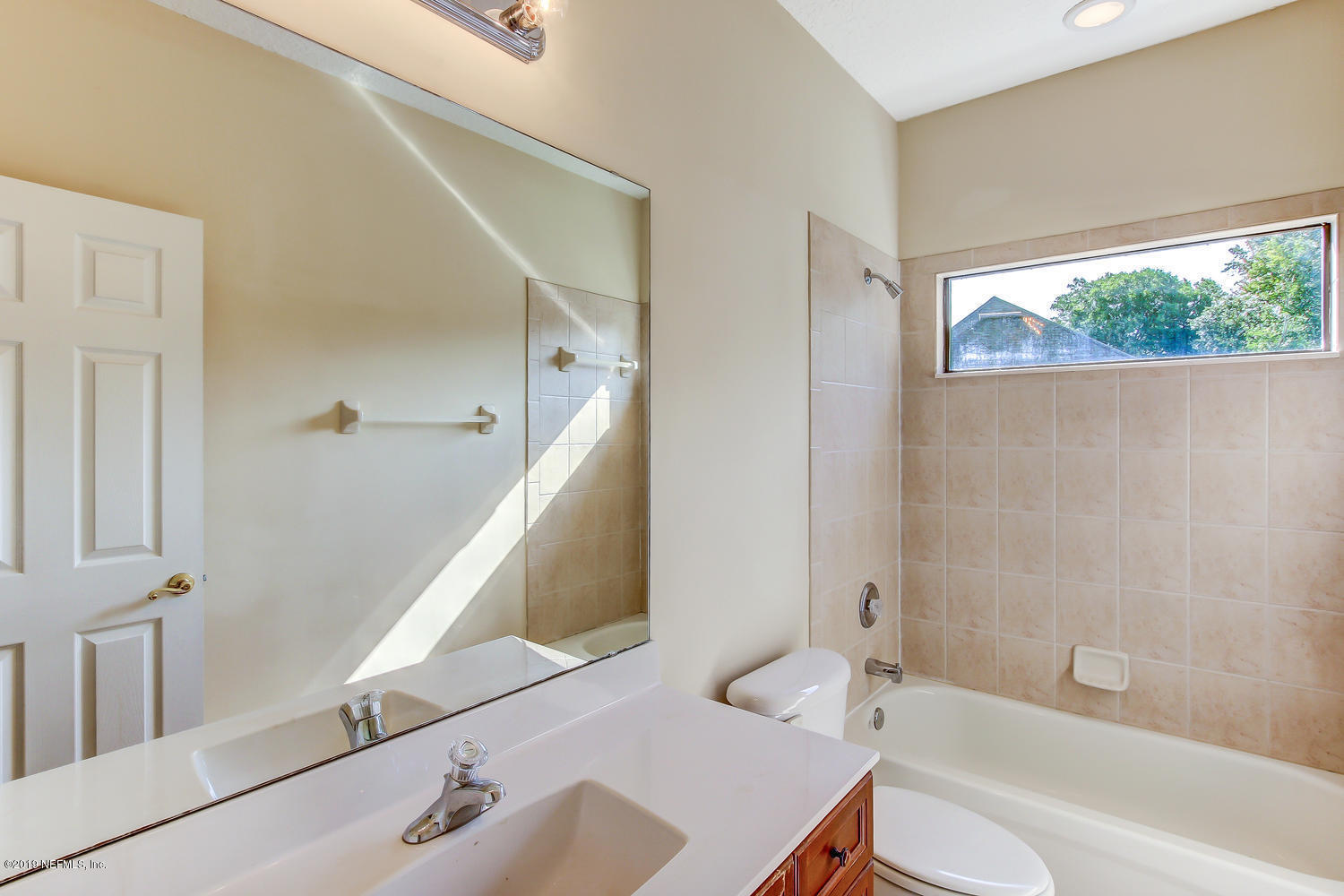 3993 Reds Gait Lane Jacksonville, FL 32223 - Photo 47 of 72 a bathroom with a bathtub and a shower