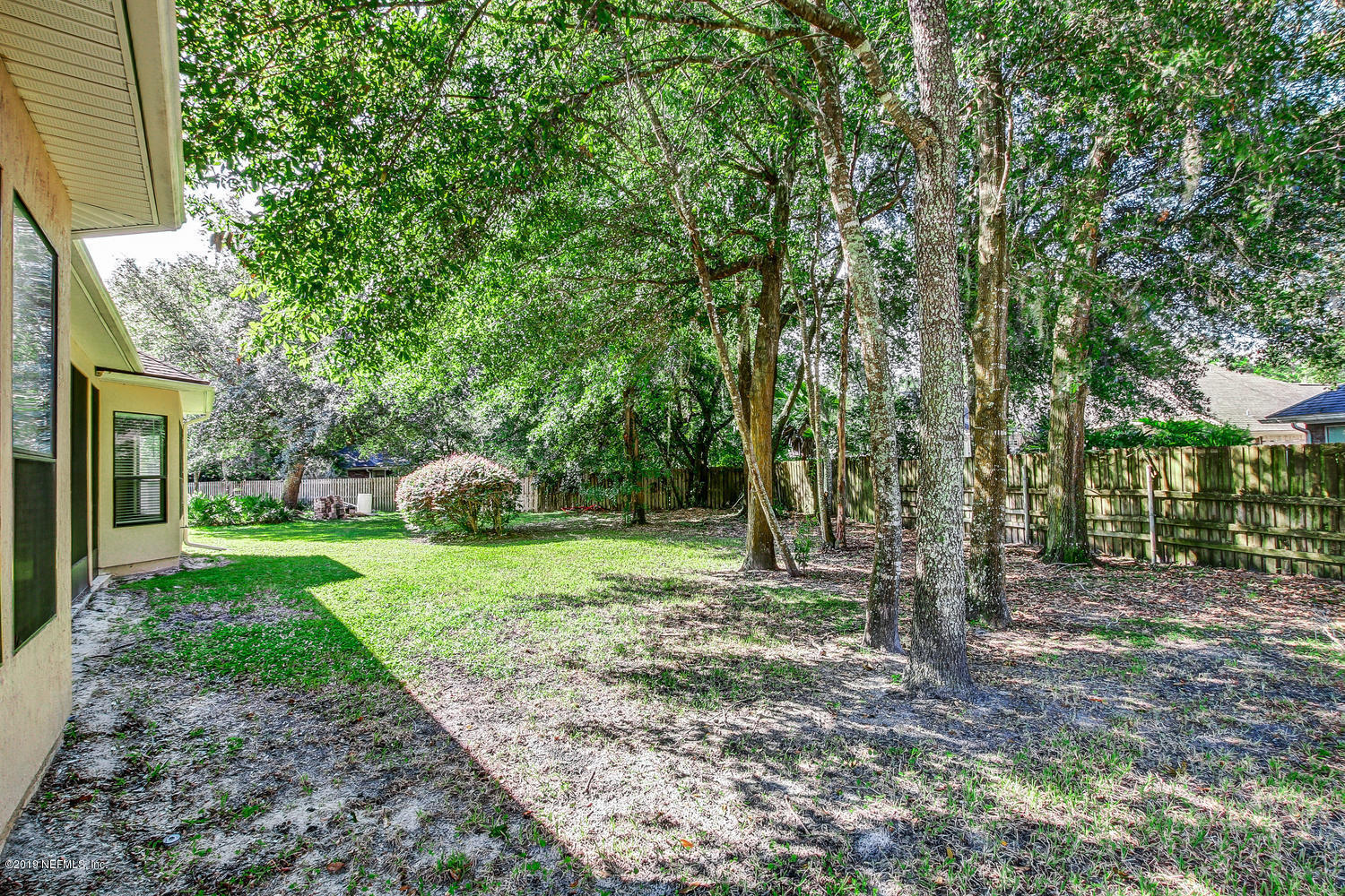 3993 Reds Gait Lane Jacksonville, FL 32223 - Photo 62 of 72 a backyard of a house with plants and large tree