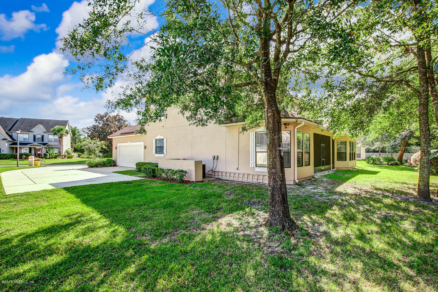 3993 Reds Gait Lane Jacksonville, FL 32223 - Photo 63 of 72 a view of a white house with a big yard and large tree
