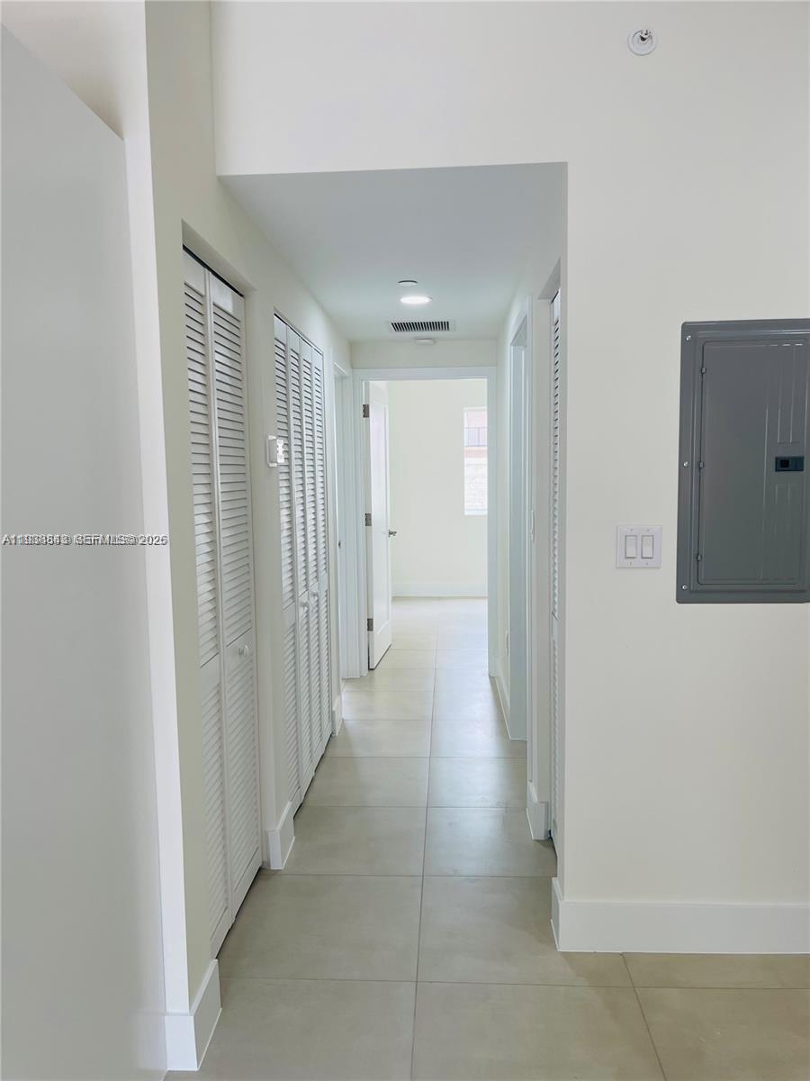 310 East 7th Street, Unit 202 Hialeah, FL 33010 - Photo 5 of 13 a view of a hallway with wooden floor