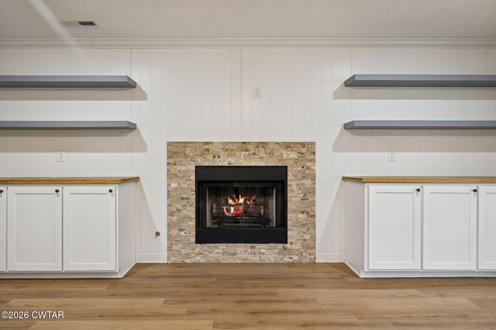 123 Walnut Hill Road Bells, TN 38006 - Photo 12 of 61 a view of an empty room with wooden floor and a fireplace