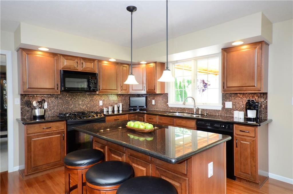 5007 Oak Point Drive McKees Rocks, PA 15136 - Photo 4 of 24 Huge 63x34 Kitchen Island, Glass Backslash, Under-Cabinet Lighting, Maple Cabinets and Granite Countertops.