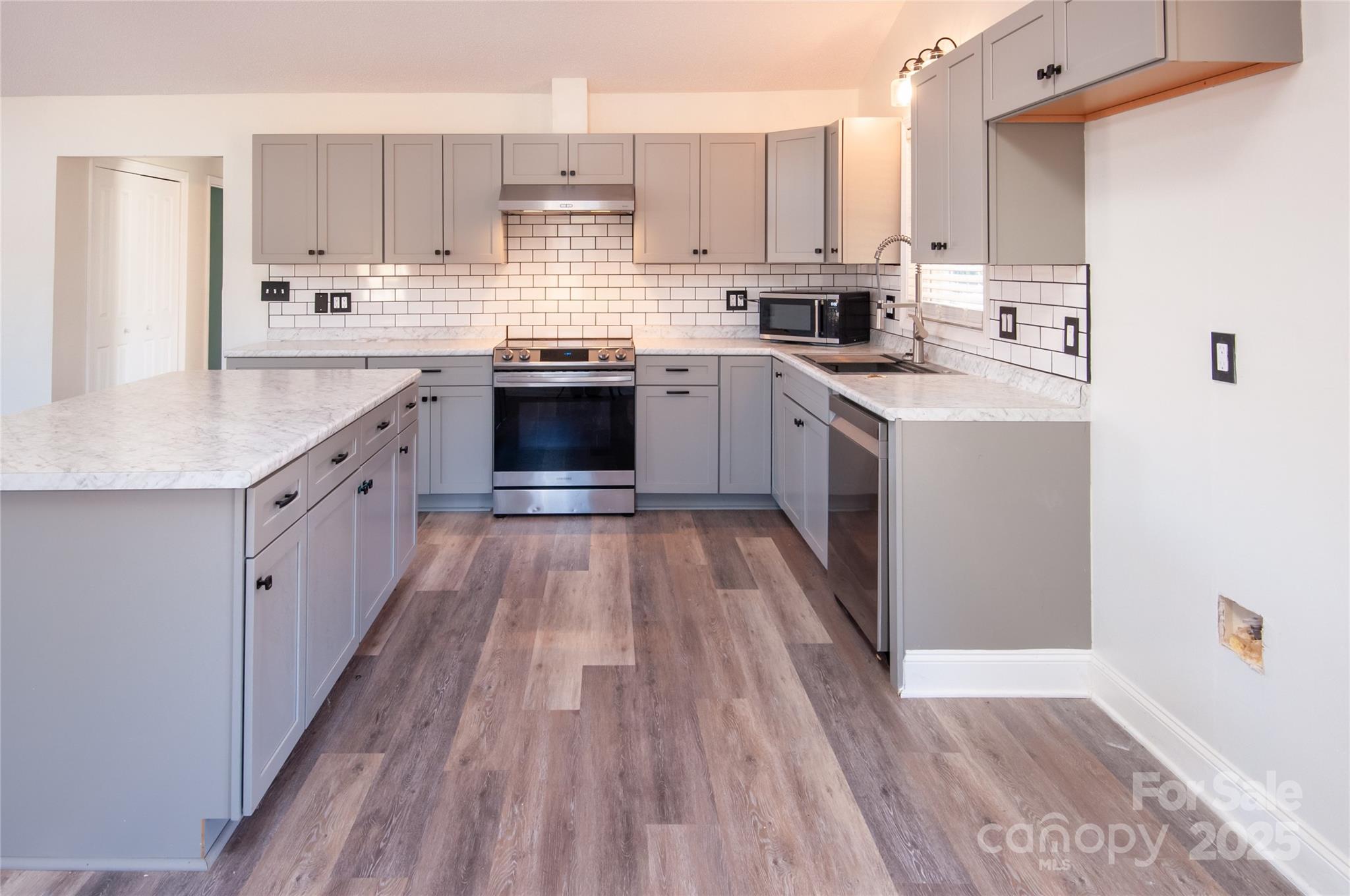 182 Red Hawk Lane Olin, NC 28660 - Photo 6 of 14 a large kitchen with a lot of counter space and wooden floor