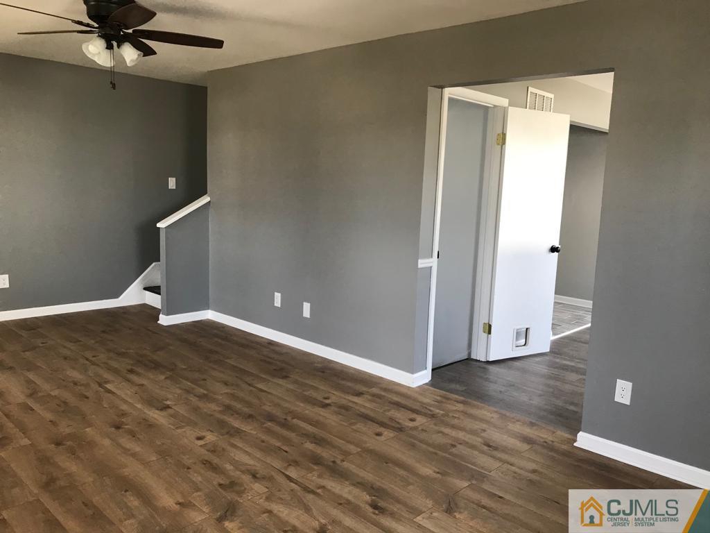 902 Salem Road Burlington, NJ 08016 - Photo 12 of 17 a view of a room with wooden floor and ceiling fan