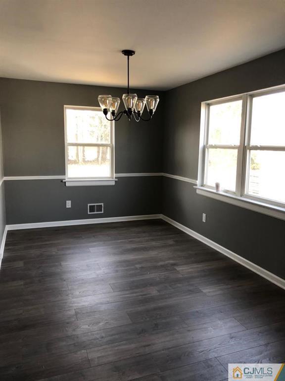 902 Salem Road Burlington, NJ 08016 - Photo 4 of 17 an empty room with wooden floor and windows