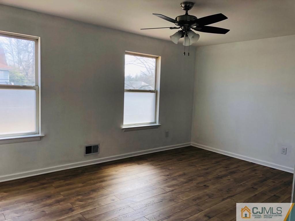 902 Salem Road Burlington, NJ 08016 - Photo 5 of 17 a view of an empty room with window and wooden floor