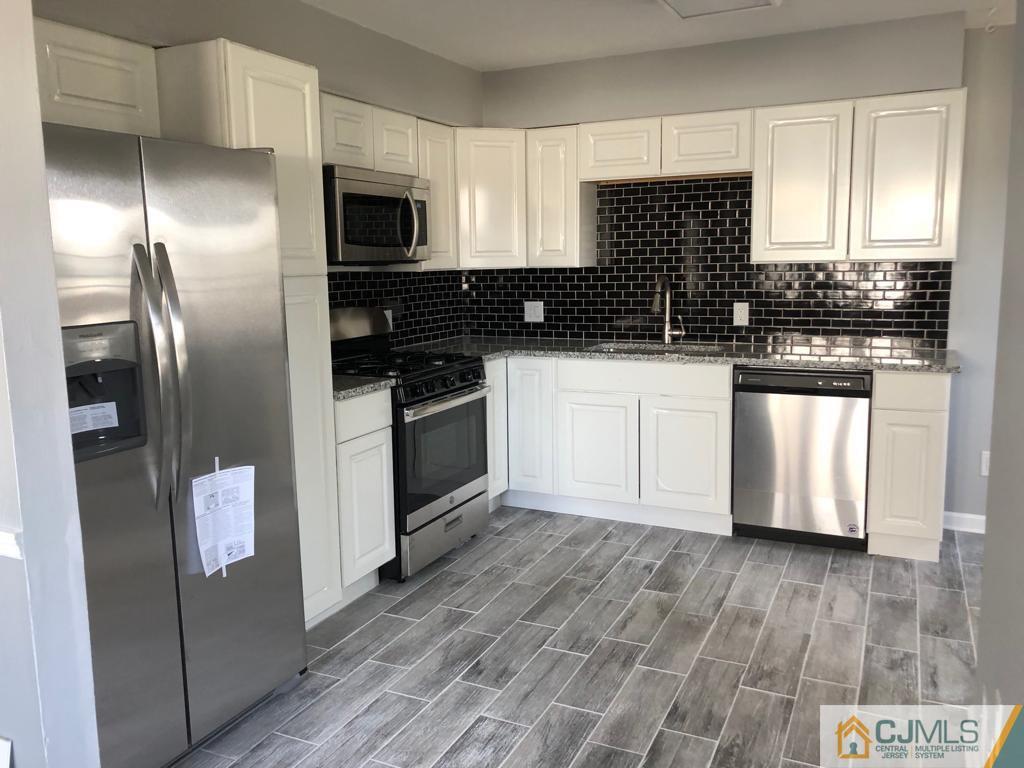 902 Salem Road Burlington, NJ 08016 - Photo 6 of 17 a kitchen with stainless steel appliances kitchen island granite countertop a stove a sink and a refrigerator