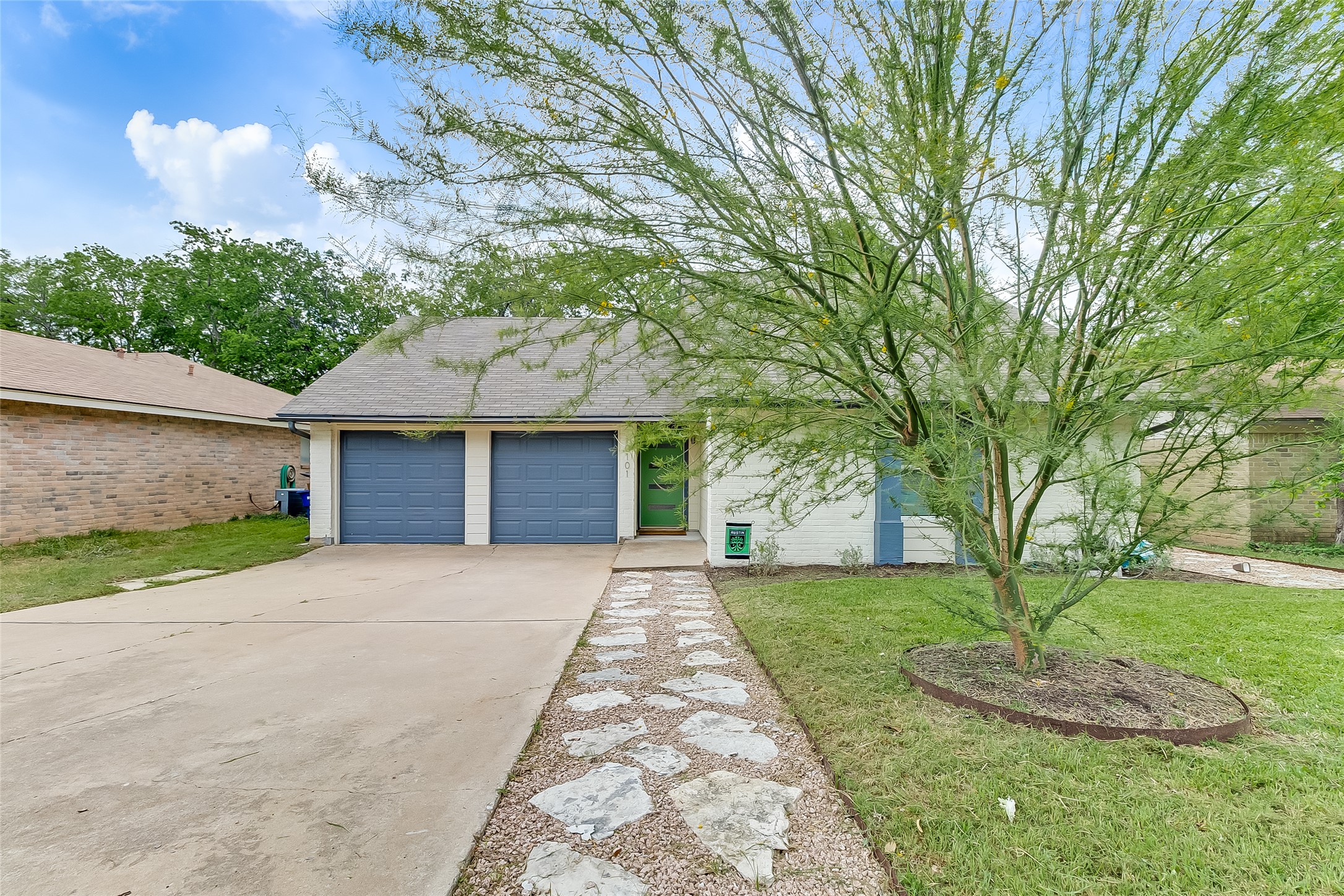 10101 Rutland Village East Austin, TX 78758 - Photo 1 of 26 View from the street, beautiful landscaped front yard with rock/gravel pathway to the front door.