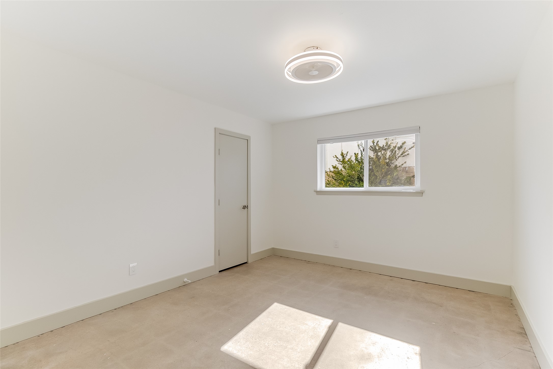 10101 Rutland Village East Austin, TX 78758 - Photo 18 of 26 Secondary downstairs bedroom, concrete floors, baseboards, huge walk-in closet