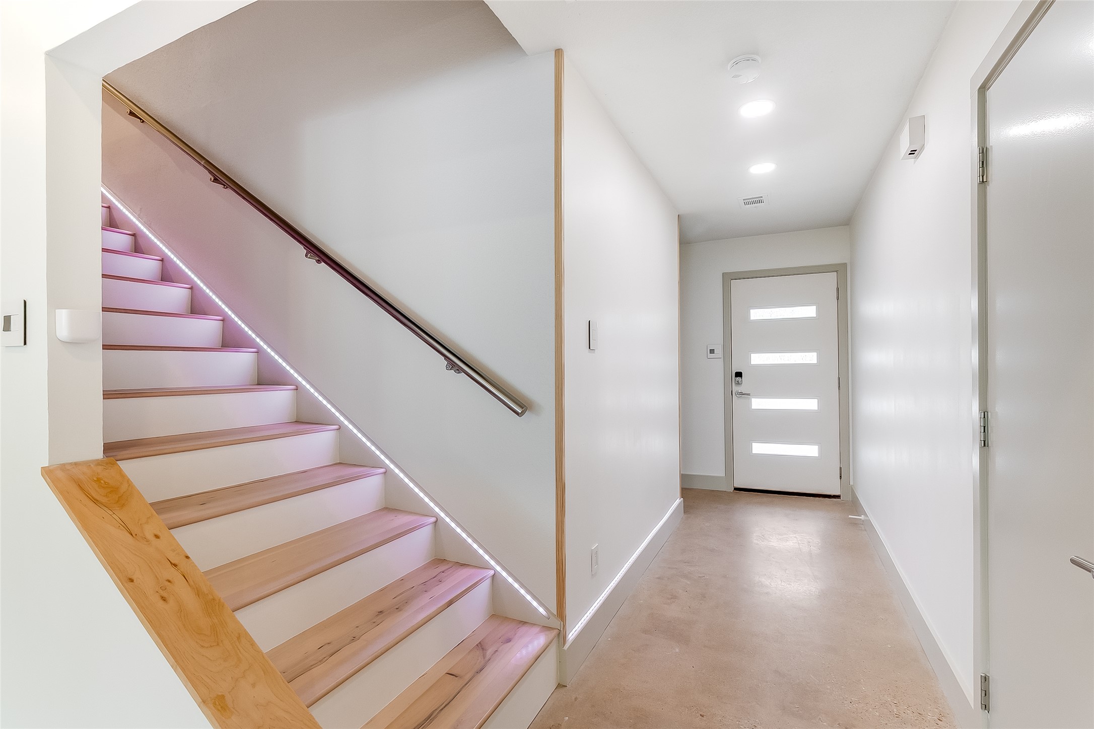 10101 Rutland Village East Austin, TX 78758 - Photo 3 of 26 Stunning entry with polished concrete floors, glass panel door allowing natural light in and lighted stairway up to the office/den/workout area.