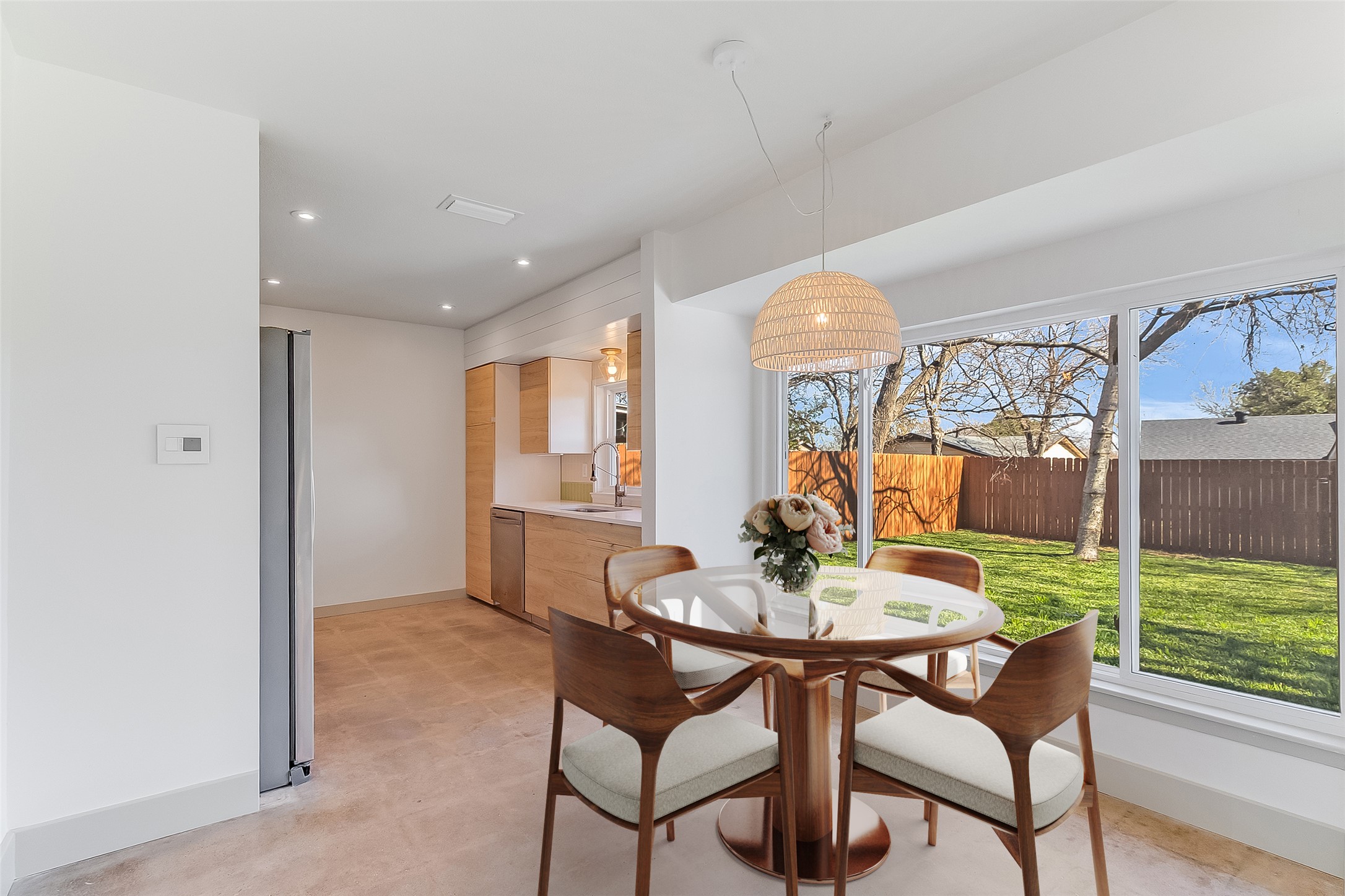 10101 Rutland Village East Austin, TX 78758 - Photo 9 of 26 Dining area adjacent to the family room, featuring large windows that fill the space with natural light and overlook the backyard. - virtually staged