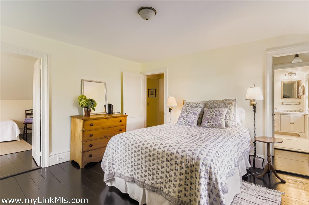 27 Spring Street Vineyard Haven, MA 02568 - Photo 42 of 58 a bedroom with a bed and wooden floor